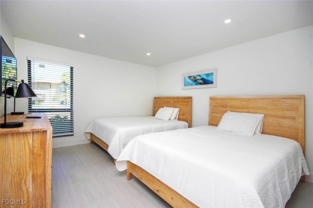 5117 Sea Bell Road, Unit E103 Sanibel, FL 33957 - Photo 16 of 24 a bedroom with two beds and painted walls