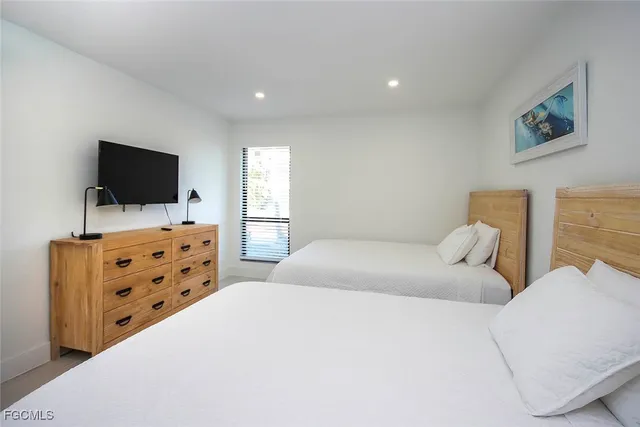 a bedroom with furniture and flat screen tv