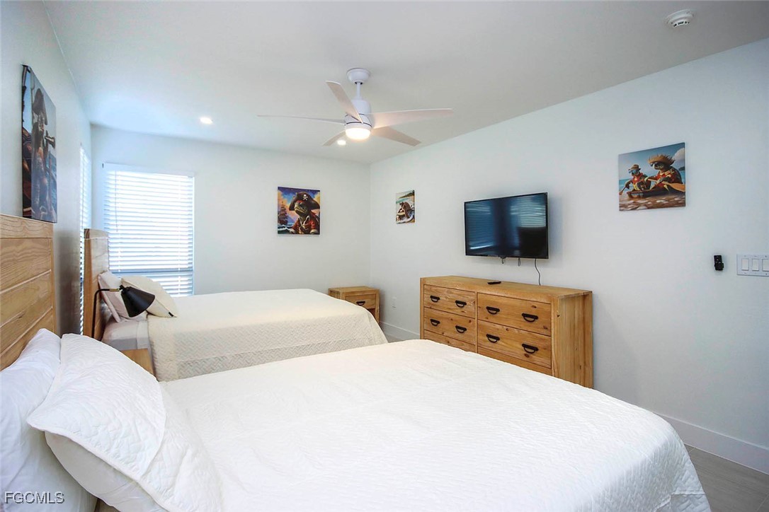 5117 Sea Bell Road, Unit E103 Sanibel, FL 33957 - Photo 21 of 24 a bedroom with two beds and a flat screen tv