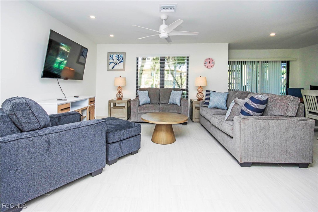 5117 Sea Bell Road, Unit E103 Sanibel, FL 33957 - Photo 3 of 24 a living room with furniture and a flat screen tv