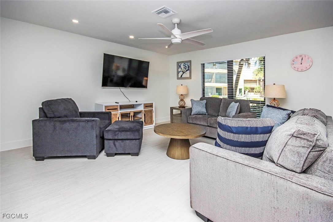 5117 Sea Bell Road, Unit E103 Sanibel, FL 33957 - Photo 4 of 24 a living room with furniture and a flat screen tv