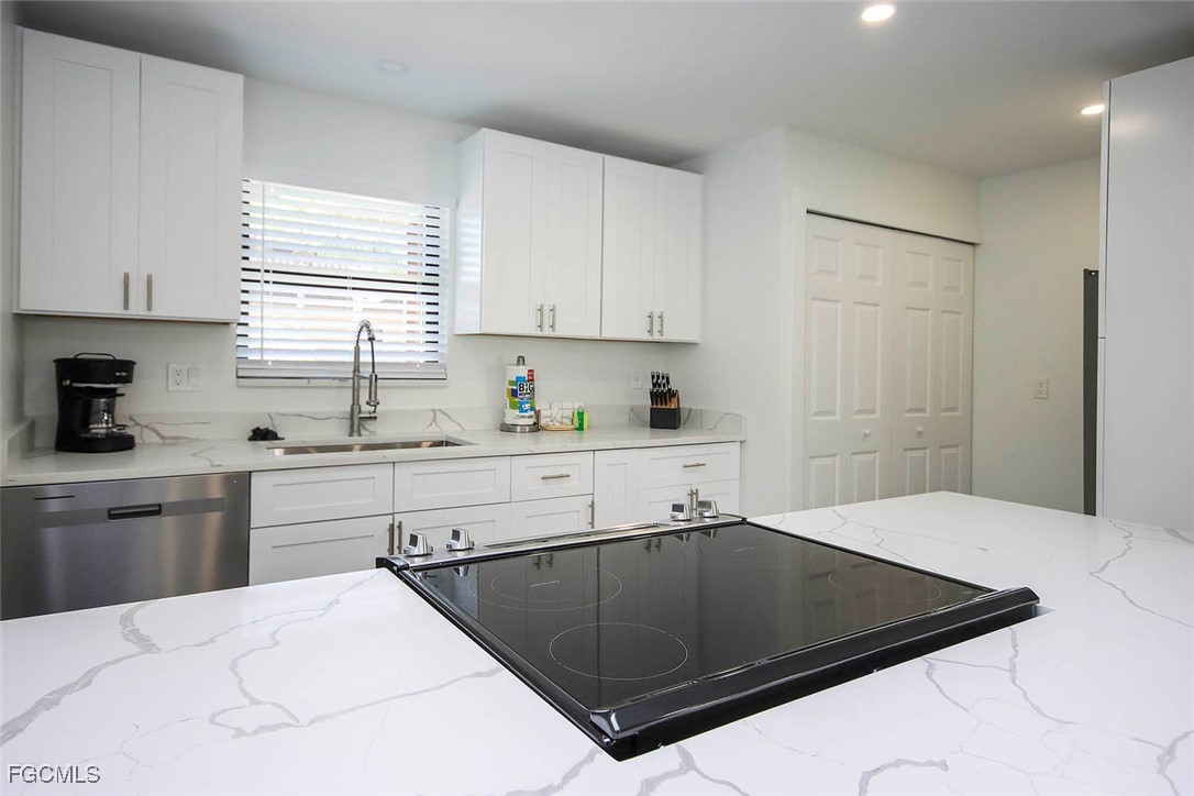 5117 Sea Bell Road, Unit E103 Sanibel, FL 33957 - Photo 9 of 24 a kitchen with a sink cabinets and window
