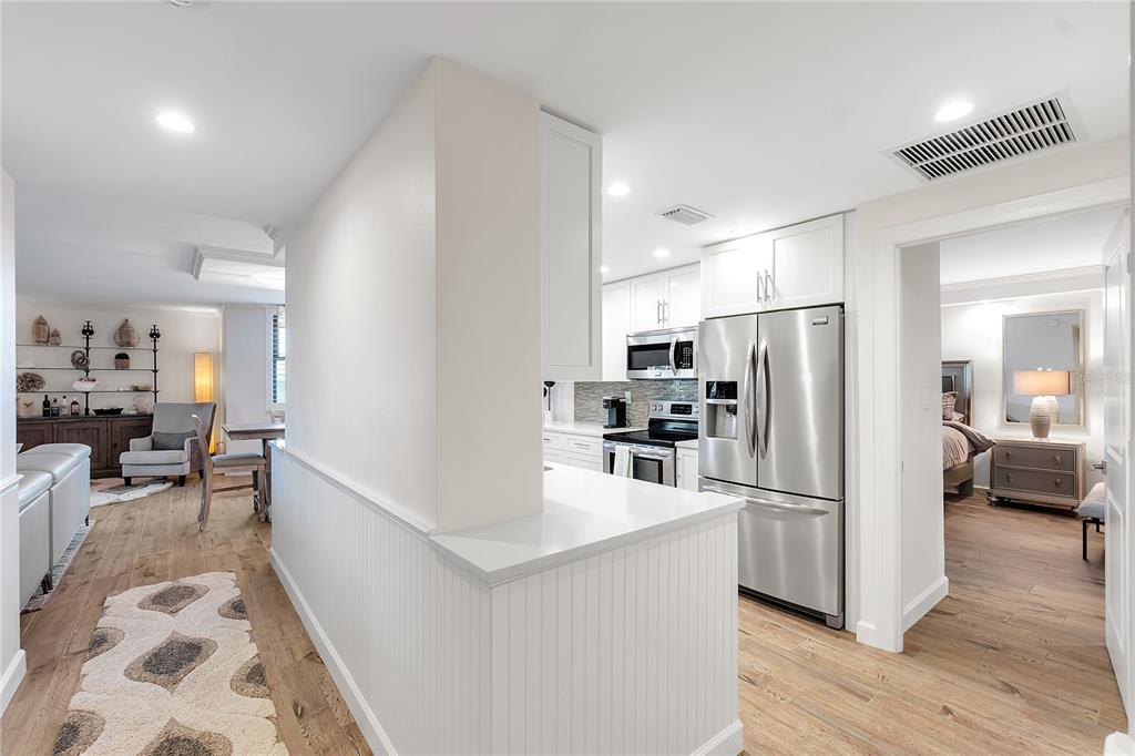 1000 Longboat Club Road, Unit 204 Longboat Key, FL 34228 - Photo 11 of 66 a kitchen with stainless steel appliances a refrigerator and a stove