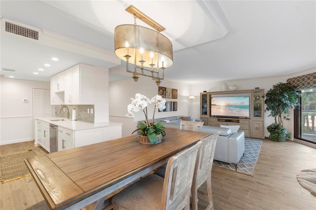 1000 Longboat Club Road, Unit 204 Longboat Key, FL 34228 - Photo 18 of 66 a view of a dining room kitchen furniture and a chandelier