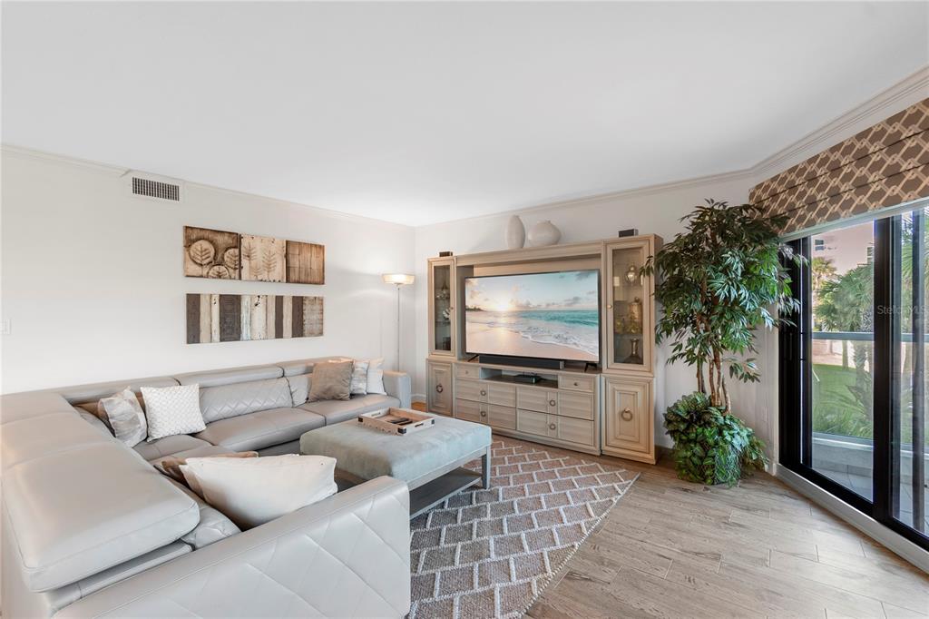 1000 Longboat Club Road, Unit 204 Longboat Key, FL 34228 - Photo 19 of 66 a living room with furniture and a flat screen tv