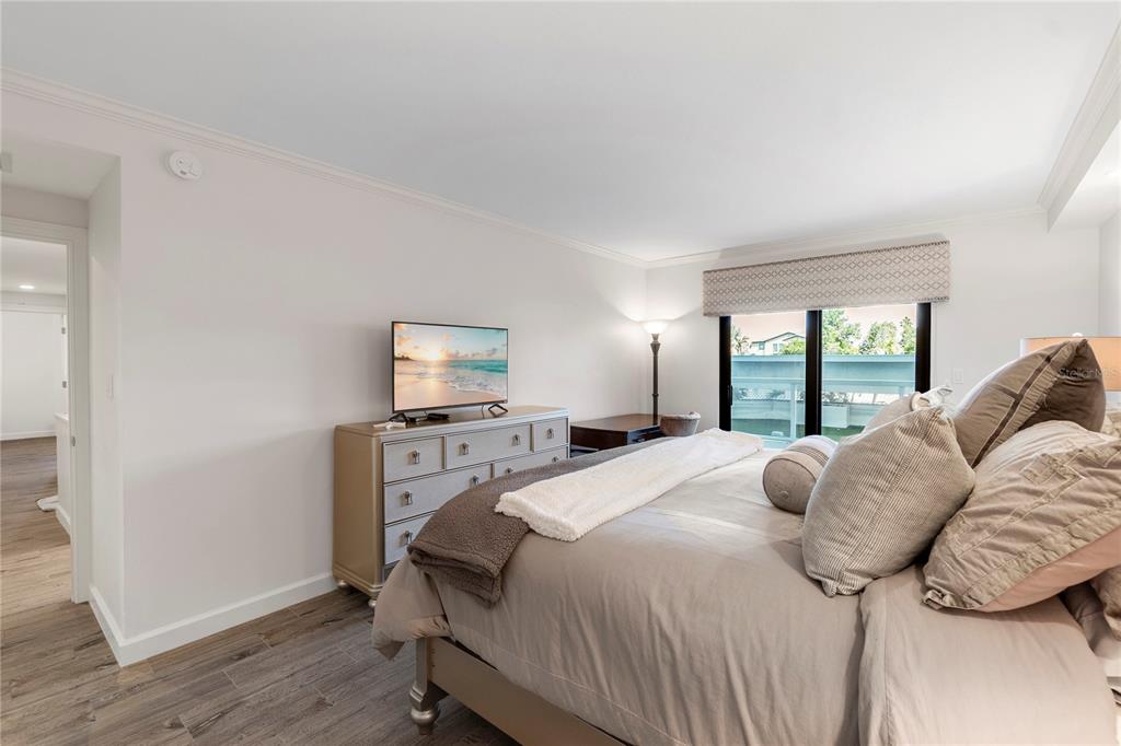 1000 Longboat Club Road, Unit 204 Longboat Key, FL 34228 - Photo 25 of 66 a bedroom with a bed and wooden floor