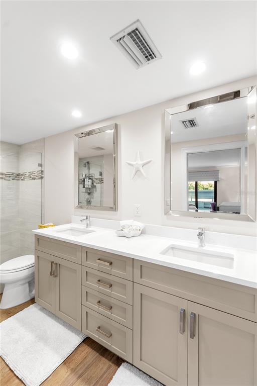 1000 Longboat Club Road, Unit 204 Longboat Key, FL 34228 - Photo 30 of 66 a bathroom with a double vanity sink mirror and toilet