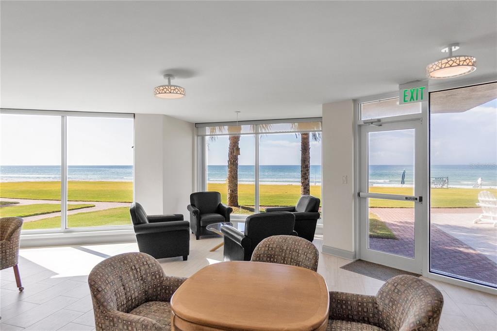 1000 Longboat Club Road, Unit 204 Longboat Key, FL 34228 - Photo 47 of 66 a living room with furniture and floor to ceiling windows