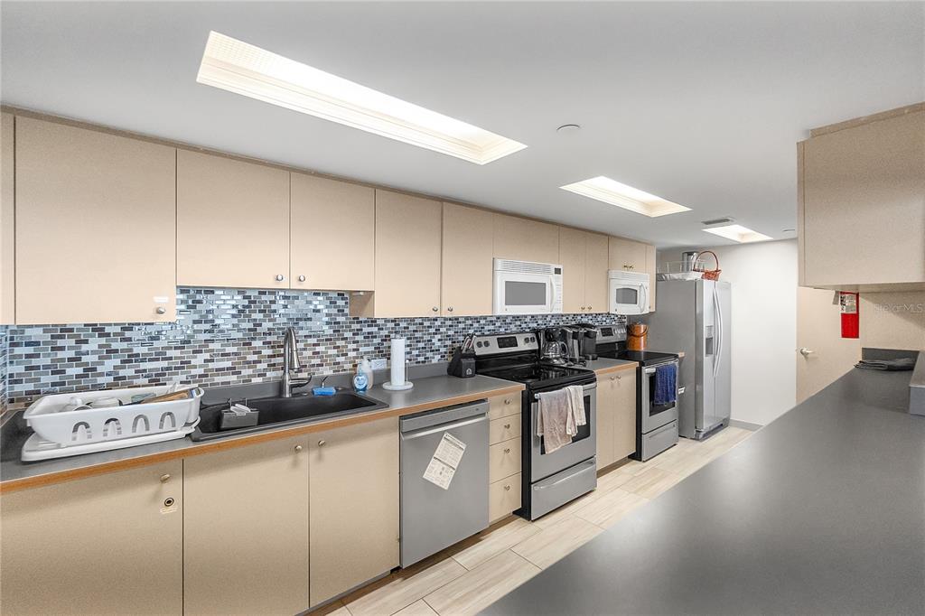 1000 Longboat Club Road, Unit 204 Longboat Key, FL 34228 - Photo 48 of 66 a kitchen with stainless steel appliances a stove a sink and a refrigerator