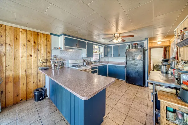 a kitchen with stainless steel appliances granite countertop a sink and a refrigerator