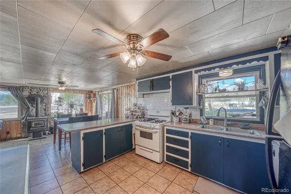 a kitchen with lots of counter top space appliances and a sink
