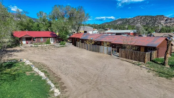a view of a house with swimming pool and a yard