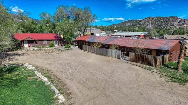 a view of a house with swimming pool and a yard