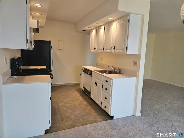 a kitchen with stainless steel appliances a stove a sink and a refrigerator