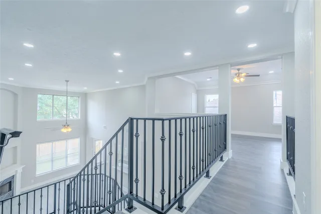a view of a hallway with wooden floor