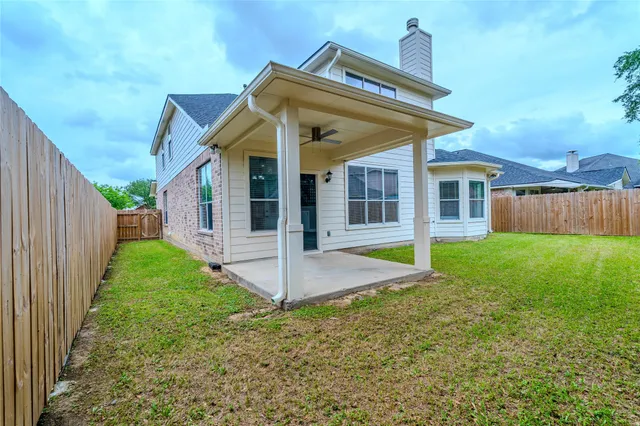 a view of a house with backyard and porch