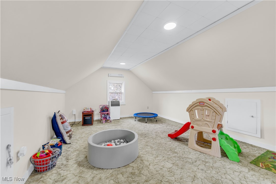 3729 Grosvenor Road Cleveland, OH 44118 - Photo 34 of 39 Recreation room featuring baseboards, lofted ceiling, and carpet floors