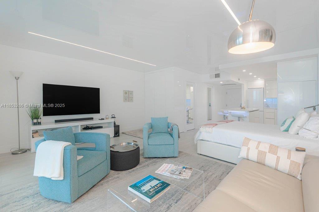 2301 Collins Avenue, Unit 811 Miami Beach, FL 33139 - Photo 11 of 42 a living room with furniture and a flat screen tv