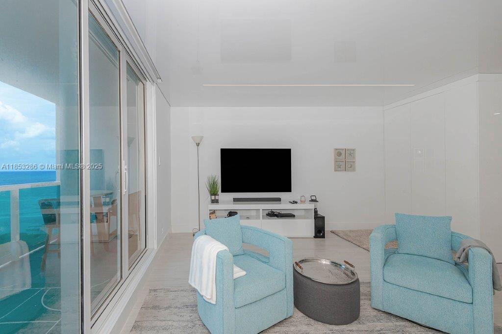 2301 Collins Avenue, Unit 811 Miami Beach, FL 33139 - Photo 12 of 42 a living room with furniture and a flat screen tv