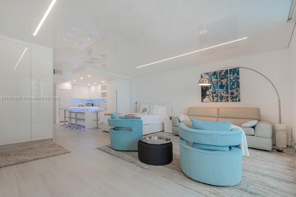 2301 Collins Avenue, Unit 811 Miami Beach, FL 33139 - Photo 13 of 42 a living room with furniture and a table