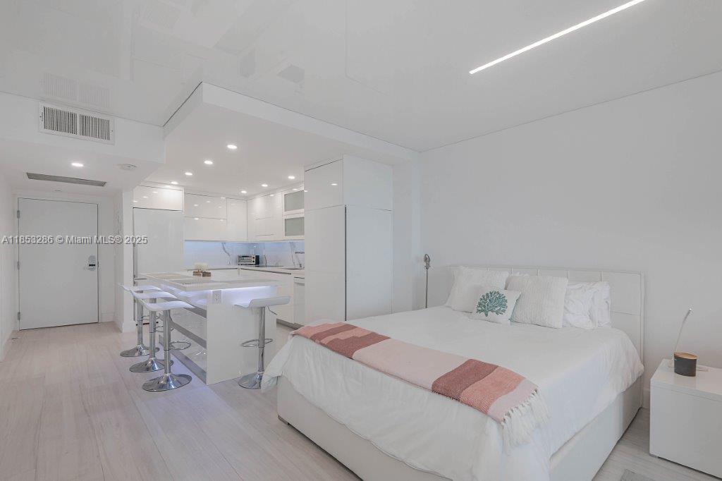 2301 Collins Avenue, Unit 811 Miami Beach, FL 33139 - Photo 14 of 42 a bedroom with a bed and a view of bathroom