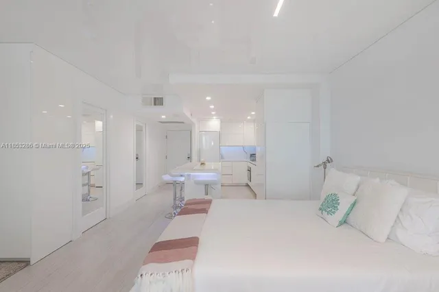 a bedroom with a bed and a large mirror