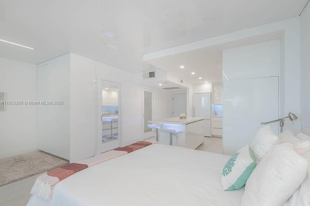 2301 Collins Avenue, Unit 811 Miami Beach, FL 33139 - Photo 16 of 42 a bedroom with a bed and a large mirror