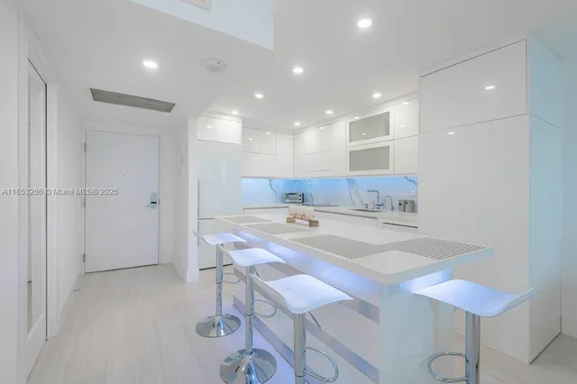 a kitchen with a sink a stove cabinets and counter space