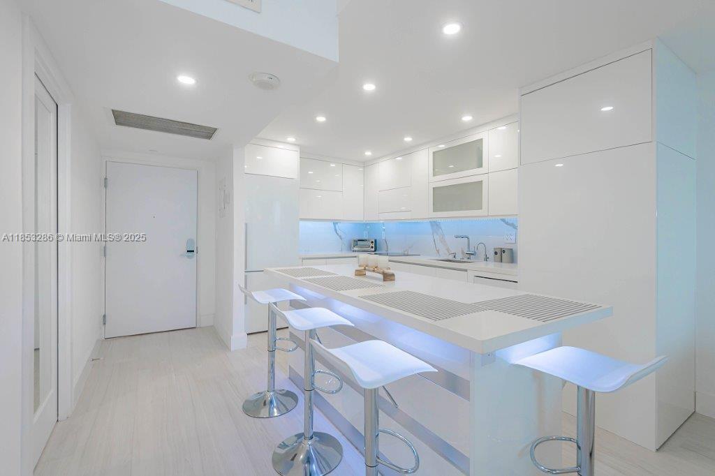 2301 Collins Avenue, Unit 811 Miami Beach, FL 33139 - Photo 18 of 42 a view of kitchen with center island and chairs