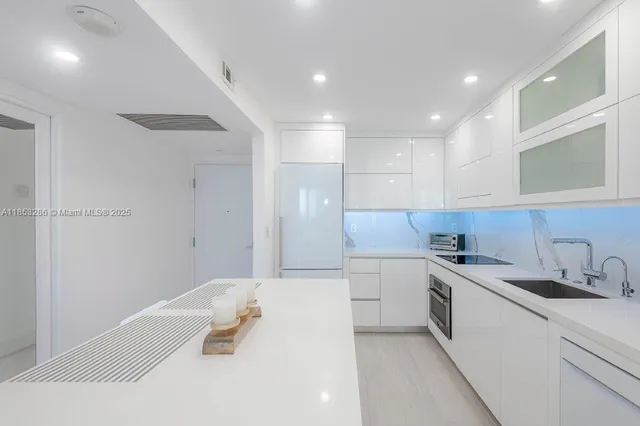 a kitchen with a sink cabinets and wooden floor