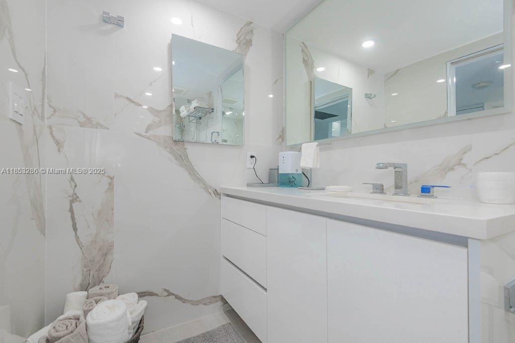 2301 Collins Avenue, Unit 811 Miami Beach, FL 33139 - Photo 22 of 42 a bathroom with a sink a toilet and shower
