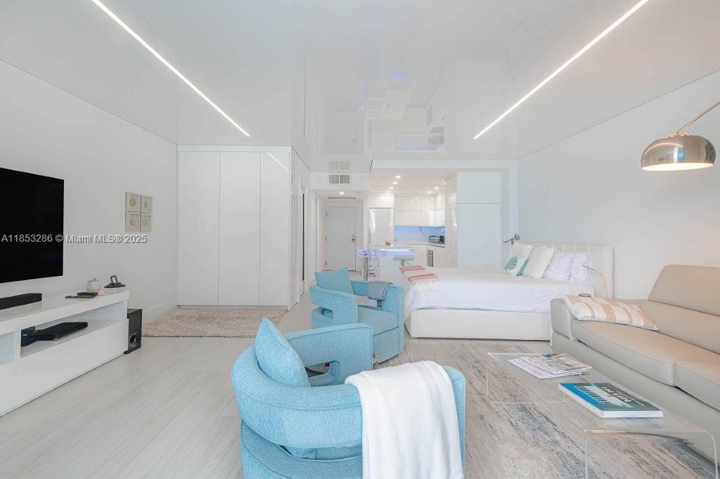 2301 Collins Avenue, Unit 811 Miami Beach, FL 33139 - Photo 27 of 42 a living room with furniture and a flat screen tv