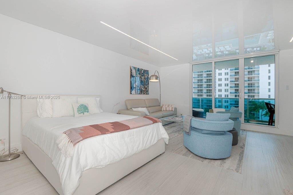2301 Collins Avenue, Unit 811 Miami Beach, FL 33139 - Photo 7 of 42 a bedroom with a bed and a large window