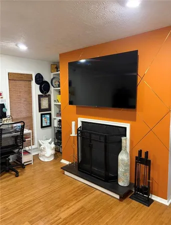 a living room with fireplace furniture and a flat screen tv