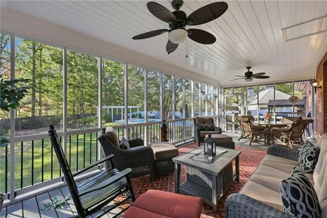 a view of a dining room with furniture a chandelier and wooden floor