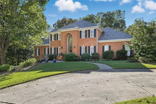 a view of a patio with chairs next to a yard