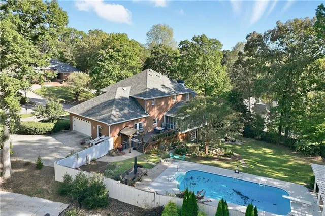 a bedroom with a bed and dresser with chair