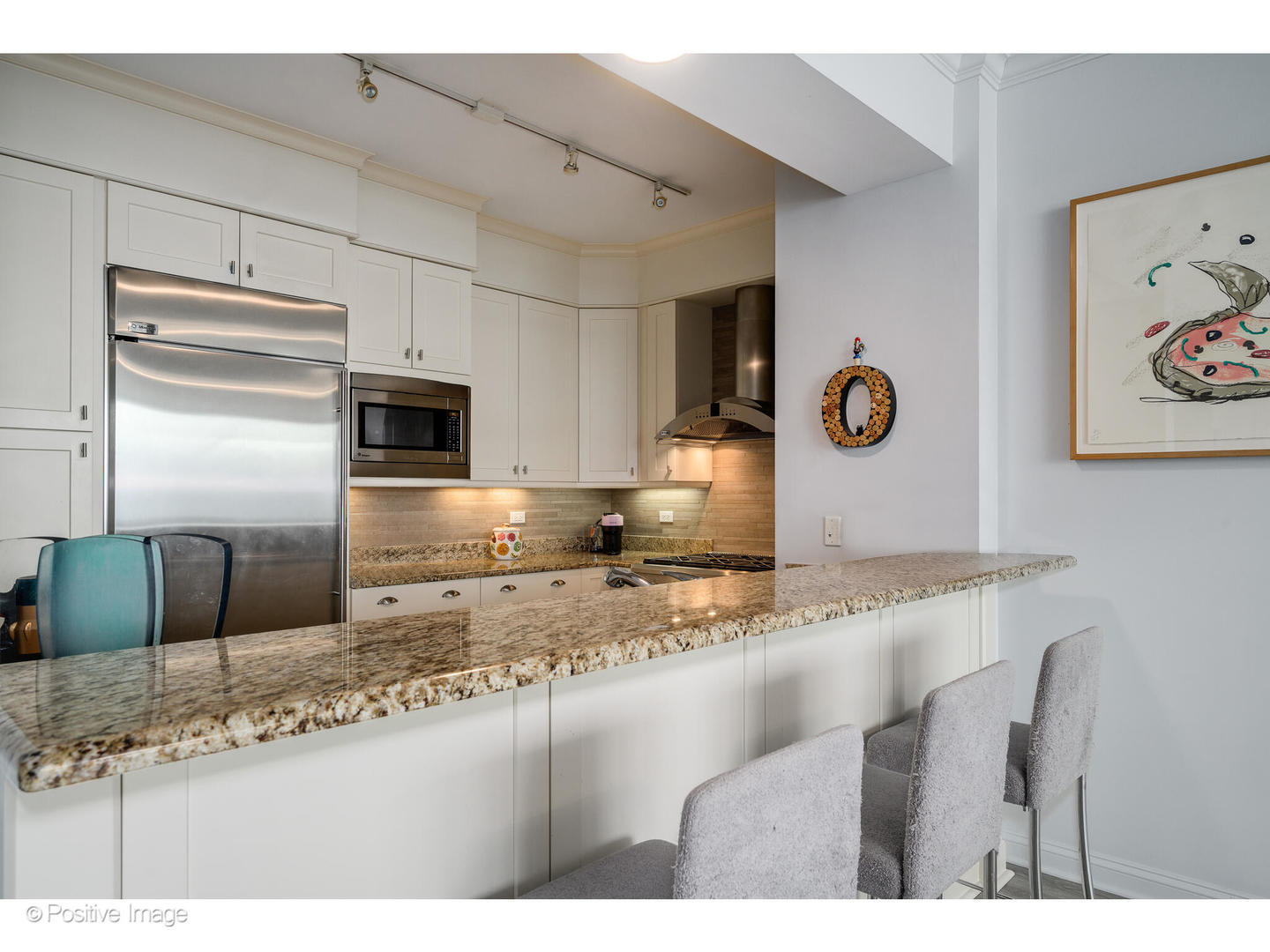 1201 South Prairie Avenue, Unit 2402 Chicago, IL 60605 - Photo 12 of 32 a kitchen with granite countertop a sink cabinets and stainless steel appliances
