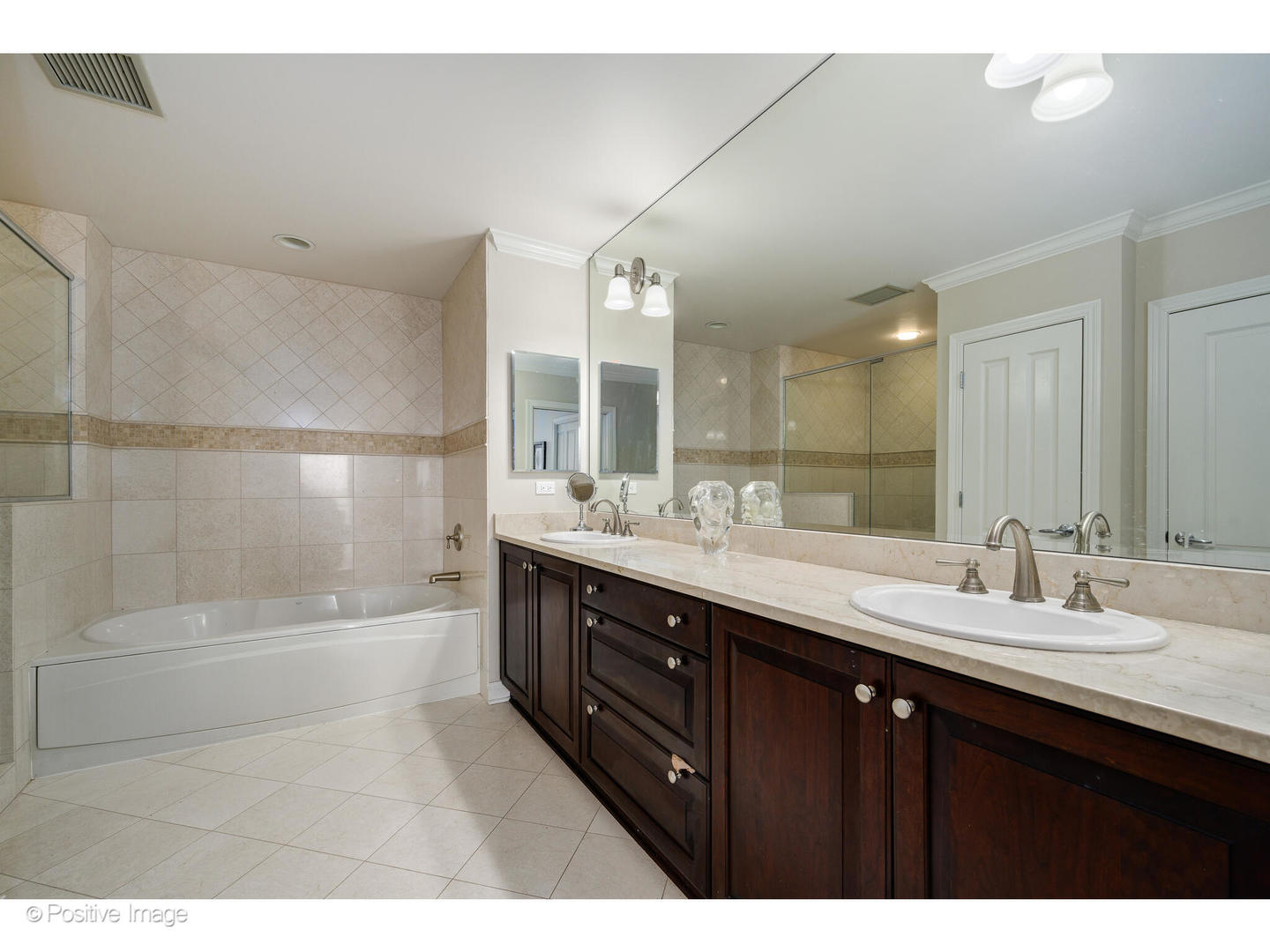 1201 South Prairie Avenue, Unit 2402 Chicago, IL 60605 - Photo 15 of 32 a bathroom with a sink double vanity granite tub shower and a mirror