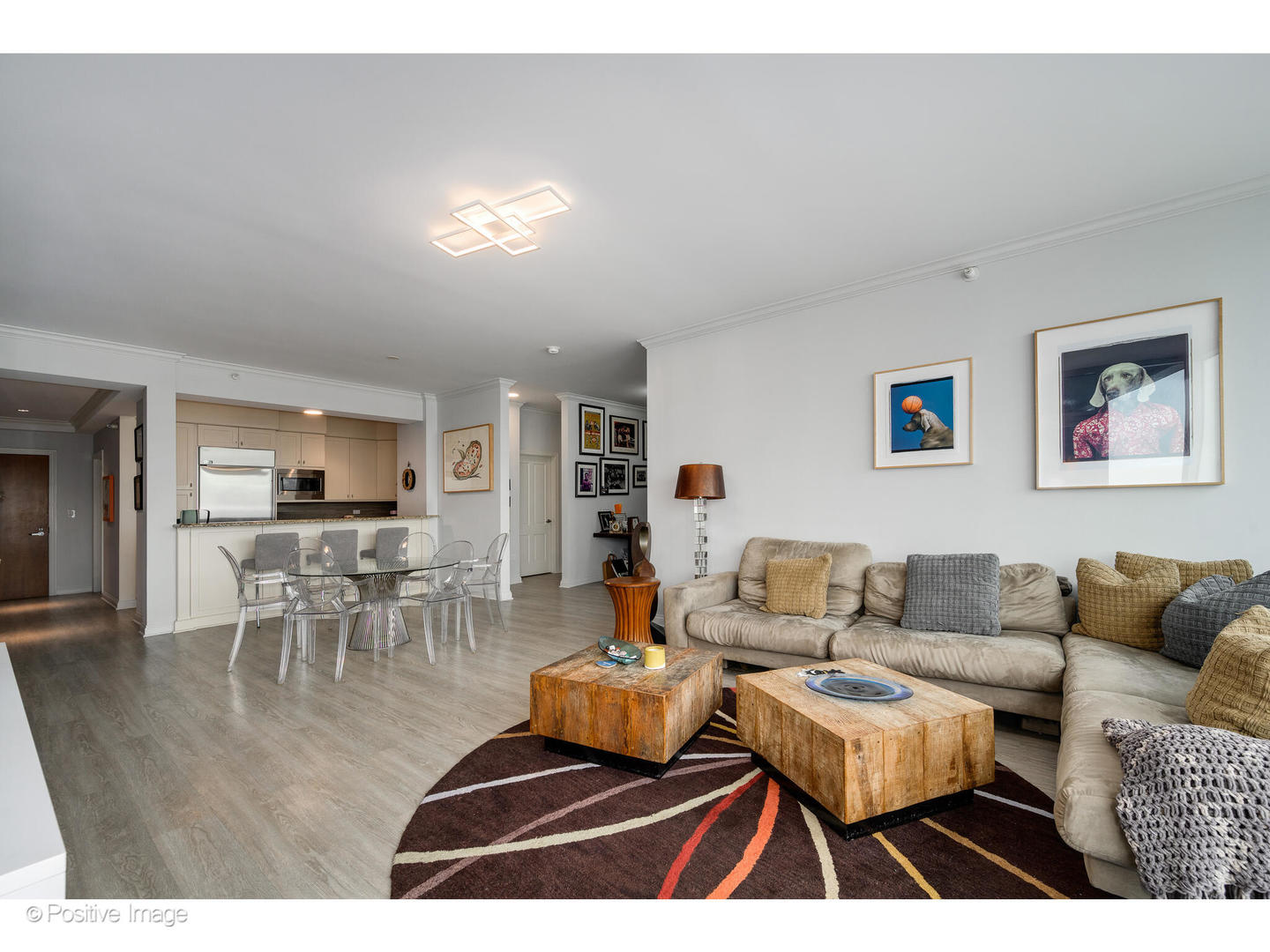 1201 South Prairie Avenue, Unit 2402 Chicago, IL 60605 - Photo 7 of 32 a living room with furniture and a dining table with wooden floor