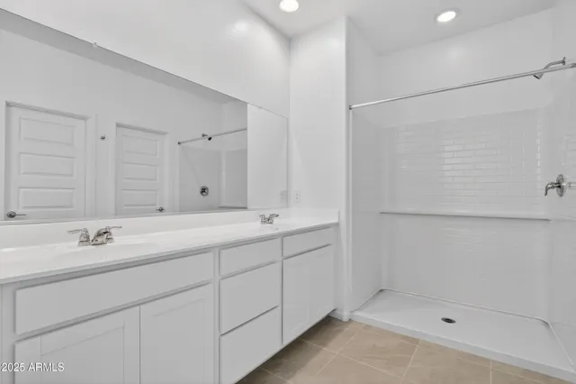 a bathroom with a double vanity sink and mirror