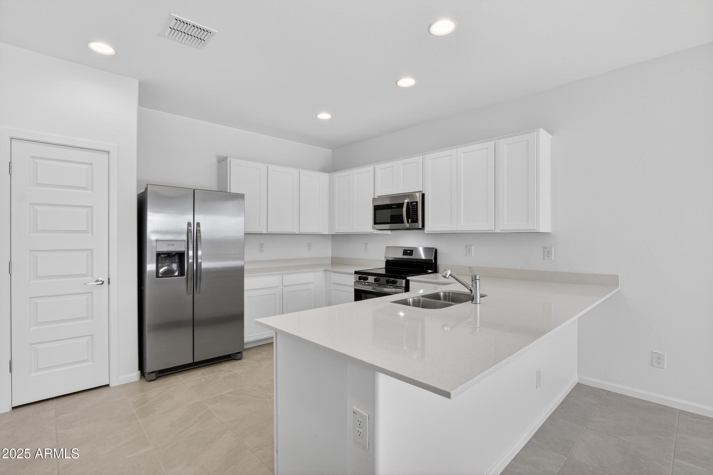 12509 East Verbina Lane Florence, AZ 85132 - Photo 2 of 31 a kitchen that has a sink cabinets and stainless steel appliances