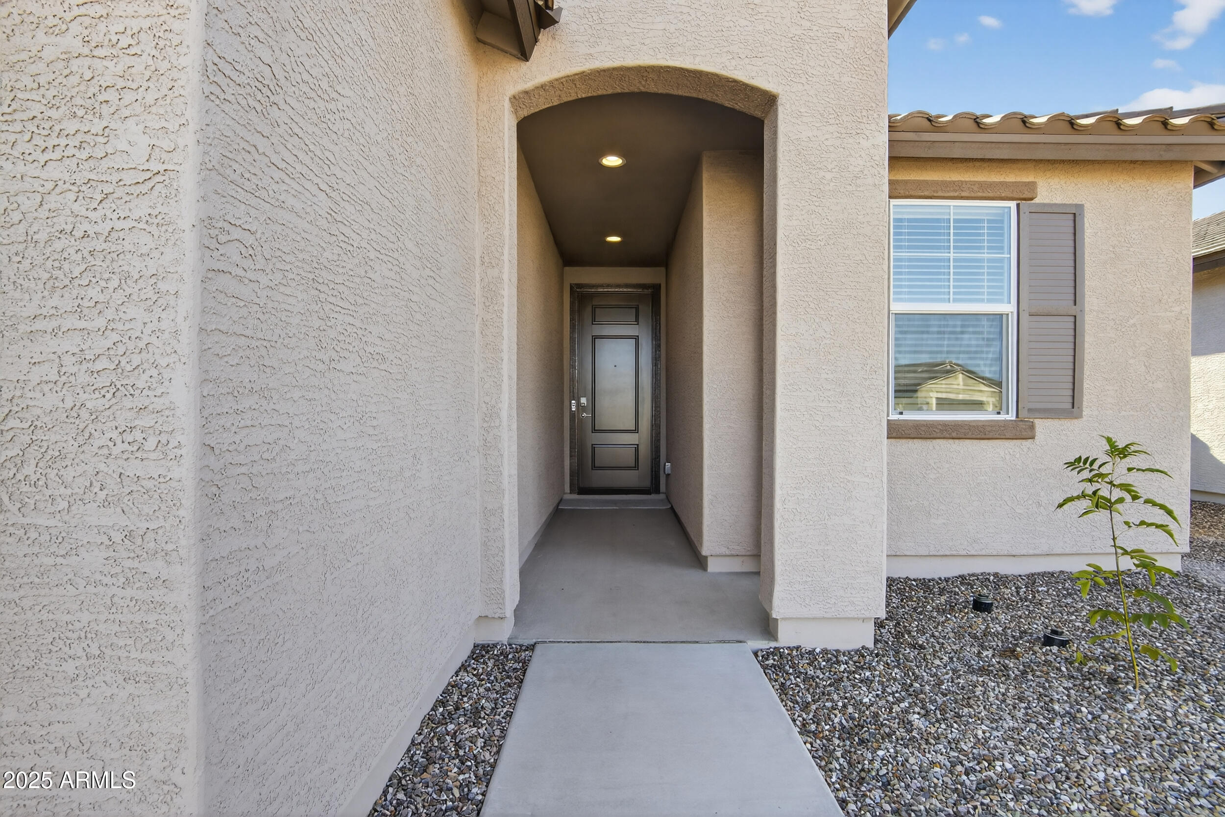 12509 East Verbina Lane Florence, AZ 85132 - Photo 7 of 31 a view of a hallway with wooden floor and a living room