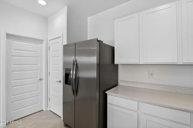 a kitchen with a refrigerator and cabinets
