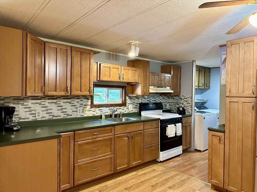 55 Heath Road Colrain, MA 01340 - Photo 14 of 32 a kitchen with stainless steel appliances granite countertop a sink stove and refrigerator
