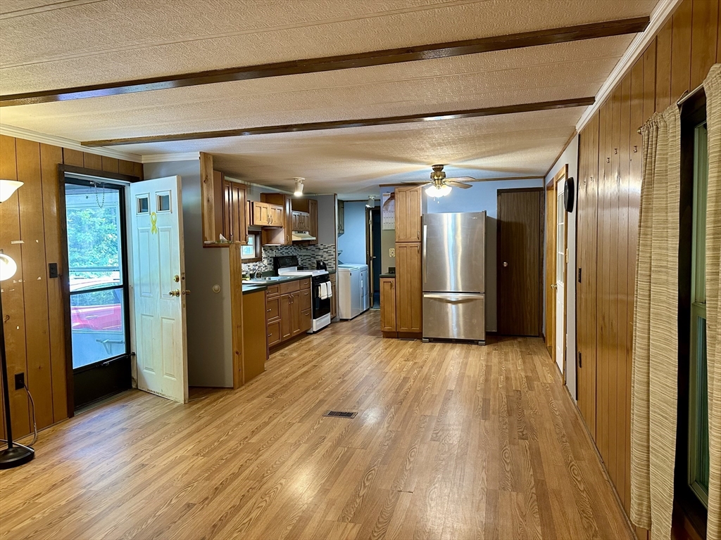55 Heath Road Colrain, MA 01340 - Photo 17 of 32 a view of a refrigerator in kitchen and wooden floor