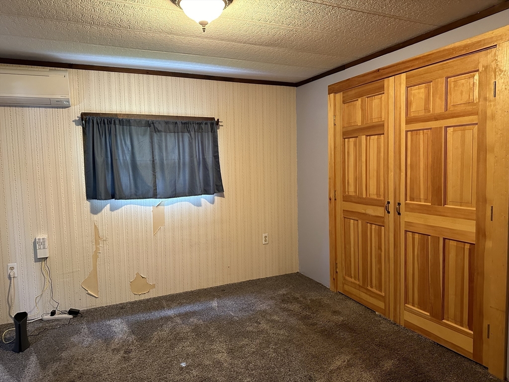 55 Heath Road Colrain, MA 01340 - Photo 25 of 32 an empty room with wooden floor and windows