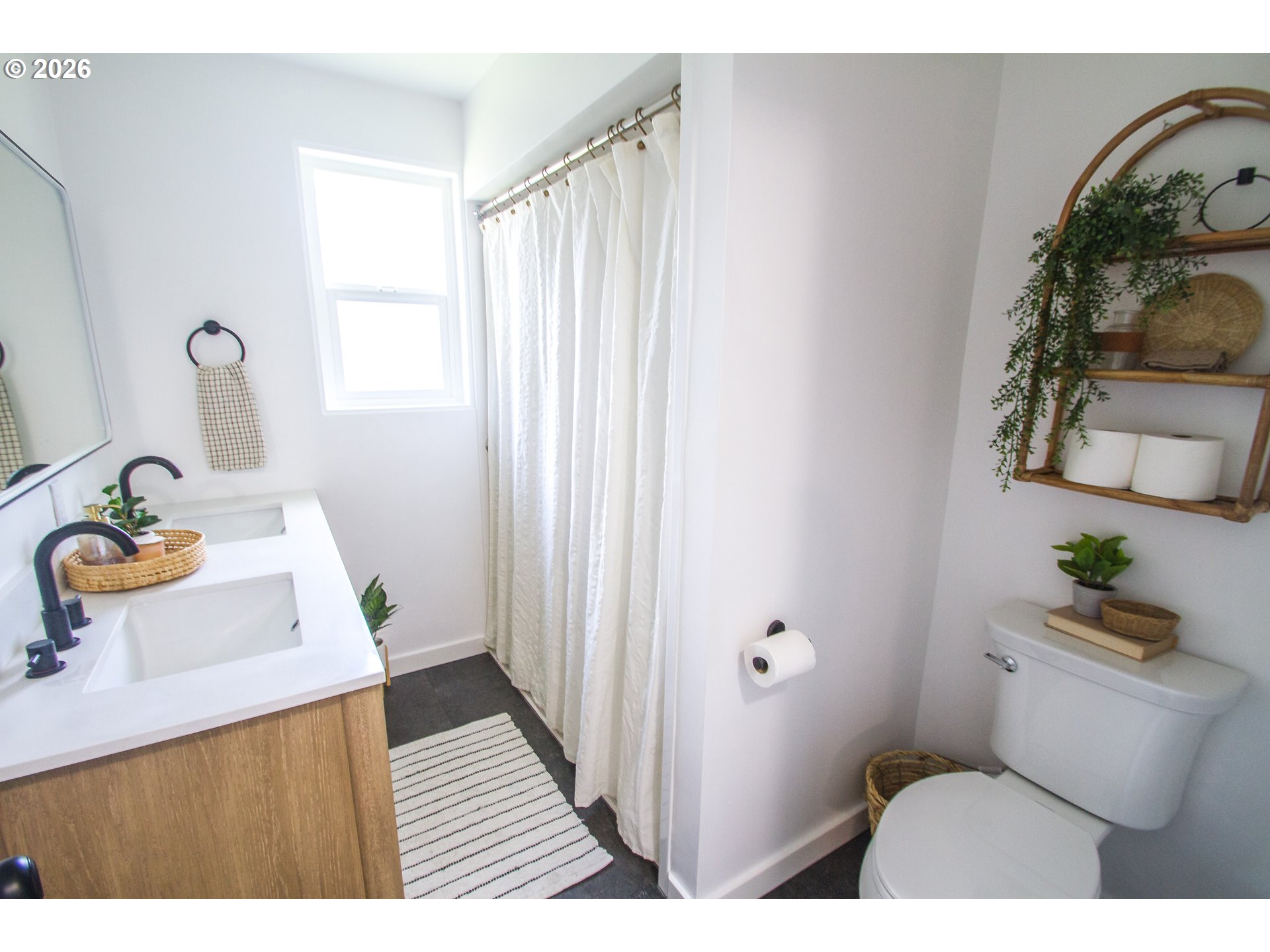 1490 Taft Street Eugene, OR 97402 - Photo 16 of 36 a bathroom with a sink a toilet and shower curtain