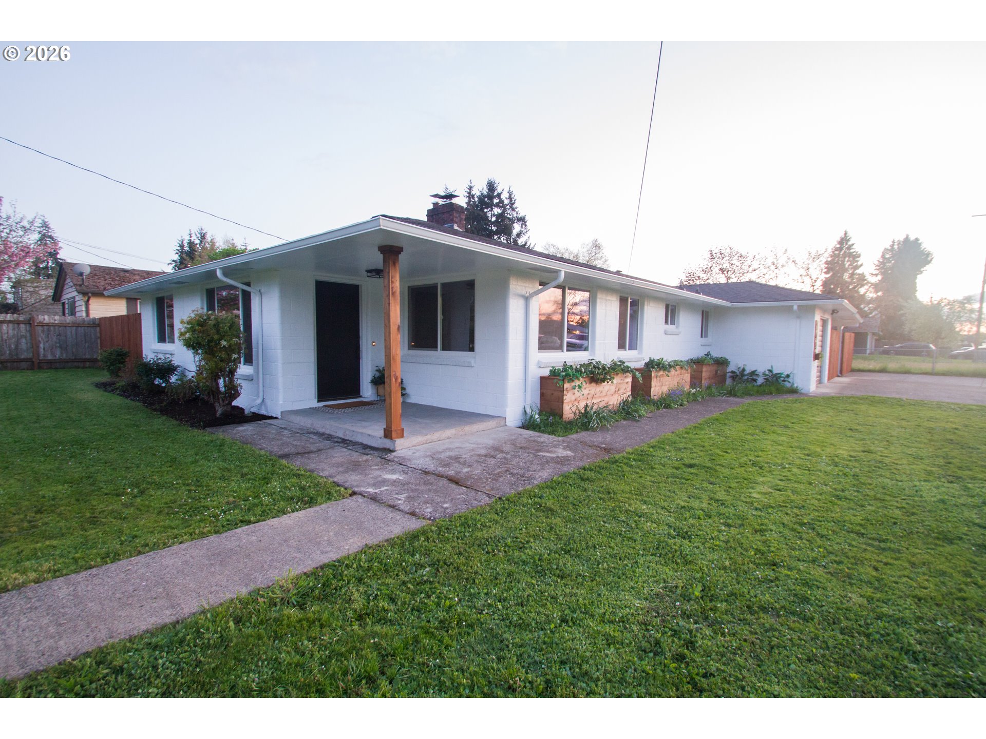 1490 Taft Street Eugene, OR 97402 - Photo 2 of 36 a front view of a house with a garden and plants