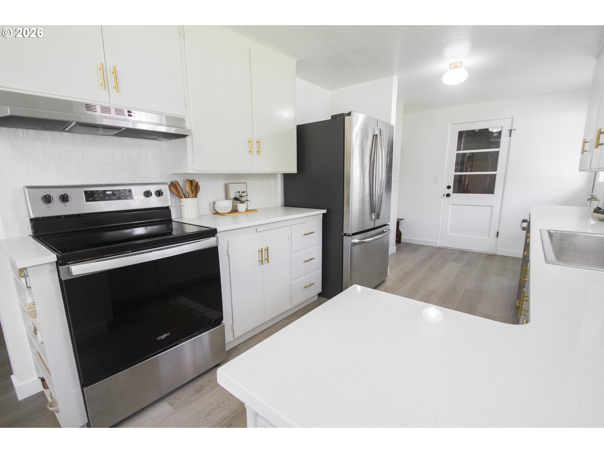 1490 Taft Street Eugene, OR 97402 - Photo 22 of 36 a kitchen with stainless steel appliances a stove a sink and a refrigerator